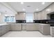 Modern kitchen featuring gray cabinets, backsplash, and marbled floors at 4605 Doss Cir, Powder Springs, GA 30127