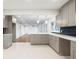 Open concept kitchen with gray cabinets, white countertops, and large windows overlooking the living area at 4605 Doss Cir, Powder Springs, GA 30127
