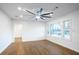 Spacious living room with hardwood floors, a ceiling fan, and bright natural light at 4605 Doss Cir, Powder Springs, GA 30127