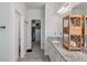 Long bathroom with granite counters, wooden storage, and walk-in closet access at 4790 Epps Ln, Cumming, GA 30040