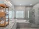 Bright bathroom featuring a soaking tub, glass shower, and granite countertops at 4790 Epps Ln, Cumming, GA 30040