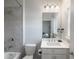 Well-lit bathroom with a shower, sink, vanity, and toilet at 4790 Epps Ln, Cumming, GA 30040