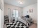 Bedroom with a small bed, patterned rug, and side table at 4790 Epps Ln, Cumming, GA 30040