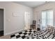 Bedroom with a small bed, patterned rug, and side table with an open door at 4790 Epps Ln, Cumming, GA 30040