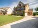 Charming two-story home with a manicured lawn and attached two-car garage at 4790 Epps Ln, Cumming, GA 30040