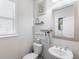 A cozy half bathroom featuring a vanity, decorative mirror, and soothing decor at 4790 Epps Ln, Cumming, GA 30040