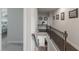 Upstairs hallway with wood railing and framed artwork on the walls at 4790 Epps Ln, Cumming, GA 30040