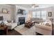 Cozy living room with a fireplace, plush seating, and hardwood floors at 4790 Epps Ln, Cumming, GA 30040