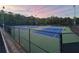 Well-maintained tennis courts with vibrant blue surfaces, enclosed by fencing, offering a great amenity for residents at 4790 Epps Ln, Cumming, GA 30040