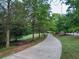 Paved walking path lined with trees and greenery, promoting an active lifestyle at 4790 Epps Ln, Cumming, GA 30040