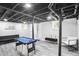Finished basement with a pool table, modern furniture, and exposed ceiling at 1673 Richland Sw Rd, Atlanta, GA 30311