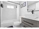 Well-lit bathroom featuring a tub/shower combo, modern fixtures, and a contemporary vanity at 1673 Richland Sw Rd, Atlanta, GA 30311