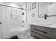 Contemporary bathroom featuring marble tile, modern fixtures, and a large vanity with storage at 1673 Richland Sw Rd, Atlanta, GA 30311