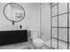 Stylish bathroom featuring a black framed shower, modern vanity, and circular mirror at 1673 Richland Sw Rd, Atlanta, GA 30311