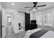 Modern bedroom featuring a ceiling fan, barn door entry to bathroom, and plentiful natural light at 1673 Richland Sw Rd, Atlanta, GA 30311