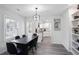 Elegant dining room with a dark wood table and modern lighting fixture at 1673 Richland Sw Rd, Atlanta, GA 30311