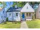 Charming home with a welcoming front porch, blue door, and well-manicured lawn at 1673 Richland Sw Rd, Atlanta, GA 30311