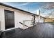 Spacious back deck, white exterior, black trim, and metal and wood railing at 3241 Broadnax Mill Rd, Loganville, GA 30052