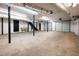 Large basement area with open floor plan, concrete flooring, stairs, and black support beams at 3241 Broadnax Mill Rd, Loganville, GA 30052