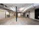 Spacious unfinished basement with concrete floor and black support beams at 3241 Broadnax Mill Rd, Loganville, GA 30052
