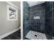 Bathroom featuring a dark tiled shower with a mosaic tile shower floor at 3241 Broadnax Mill Rd, Loganville, GA 30052