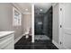 Bathroom with tile flooring, glass shower door, and white fixtures at 3241 Broadnax Mill Rd, Loganville, GA 30052