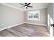Bedroom featuring hardwood floors, a ceiling fan, and a bright window at 3241 Broadnax Mill Rd, Loganville, GA 30052