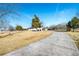 Long driveway leads up to the single story home with an American flag waving in the yard at 3241 Broadnax Mill Rd, Loganville, GA 30052