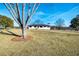 Charming ranch-style home with a large front yard and mature trees on a sunny day at 3241 Broadnax Mill Rd, Loganville, GA 30052