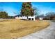 Sprawling ranch features an American flag, black trim, garage, and outbuilding at 3241 Broadnax Mill Rd, Loganville, GA 30052