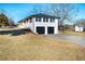 Rear exterior showcasing a two-car garage and an inviting outdoor living space above at 3241 Broadnax Mill Rd, Loganville, GA 30052