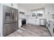 Modern kitchen with stainless steel appliances, white cabinetry, and a subway tile backsplash at 3241 Broadnax Mill Rd, Loganville, GA 30052