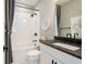 Elegant bathroom featuring a shower-tub combo, black fixtures, and stylish vanity at 3525 Brynhurst Dr, Cumming, GA 30028