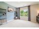Serene bedroom with calming blue wall, open shelving, and a bright, inviting window view at 3525 Brynhurst Dr, Cumming, GA 30028