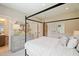 Cozy bedroom with a canopy bed, dresser with mirror, and ensuite bathroom at 3525 Brynhurst Dr, Cumming, GA 30028