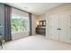 Bright bedroom featuring a large window with natural light and closet with double doors at 3525 Brynhurst Dr, Cumming, GA 30028