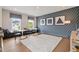 Playful bonus room with blue accent wall, geometric art, and window seats, perfect for entertainment at 3525 Brynhurst Dr, Cumming, GA 30028