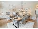 Bright dining area with a modern table, stylish chairs, and an adjacent open-concept kitchen at 3525 Brynhurst Dr, Cumming, GA 30028