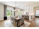 Elegant dining area with a modern table, stylish chairs, and adjacent kitchen island at 3525 Brynhurst Dr, Cumming, GA 30028