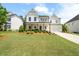 Beautiful two-story home with a manicured lawn and charming front porch at 3525 Brynhurst Dr, Cumming, GA 30028