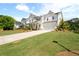 Inviting two-story home with a landscaped front yard, long driveway, and attached garage at 3525 Brynhurst Dr, Cumming, GA 30028