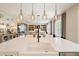 Open concept kitchen showcasing a large island with seating, stylish pendant lights, and views of the living room at 3525 Brynhurst Dr, Cumming, GA 30028
