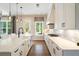 Bright kitchen boasts white cabinetry, subway tile backsplash, and a farmhouse sink beneath pendant lighting at 3525 Brynhurst Dr, Cumming, GA 30028