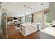Open-concept kitchen flows into the living area and features a large island with a farmhouse sink and pendant lights at 3525 Brynhurst Dr, Cumming, GA 30028