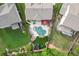 Aerial view of a backyard oasis with pool, lounge area, and well-maintained landscaping at 3939 Soft Wind Ter, Buford, GA 30518