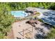 Aerial view of community pool and playground with ample parking and landscaping at 3939 Soft Wind Ter, Buford, GA 30518