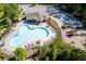 Aerial view of community amenities with large pool, clubhouse, playground, parking, and landscaping at 3939 Soft Wind Ter, Buford, GA 30518