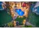 Aerial view of a backyard with an in-ground pool, outdoor seating, a large lawn, and mature landscaping at 3939 Soft Wind Ter, Buford, GA 30518