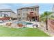 A luxurious backyard featuring a pool, lounge chairs, lush greenery, and a covered outdoor seating area at 3939 Soft Wind Ter, Buford, GA 30518