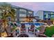 Beautiful backyard with a seating area around a firepit with a swimming pool and deck under string lights at 3939 Soft Wind Ter, Buford, GA 30518